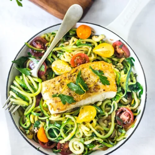 Healthy grilled fish served on zucchini noodles with cherry tomatoes and herbs at Bollywood Masalaz Kuta in Bali