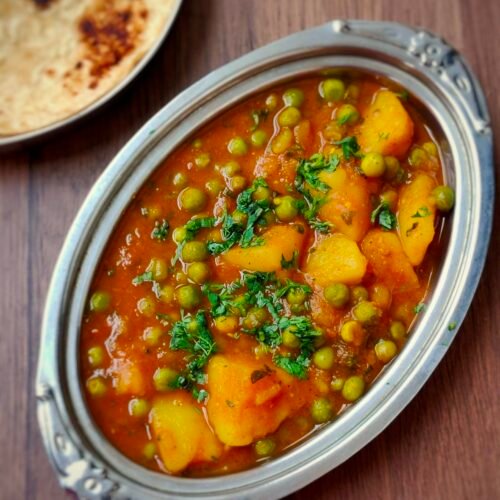 Traditional aloo matar curry with potatoes and green peas in spiced tomato gravy served at Bollywood Masalaz Kuta
