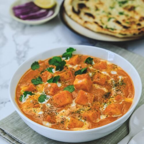 Creamy paneer butter masala served with garlic naan at Bollywood Masalaz Kuta Indian restaurant in Bali